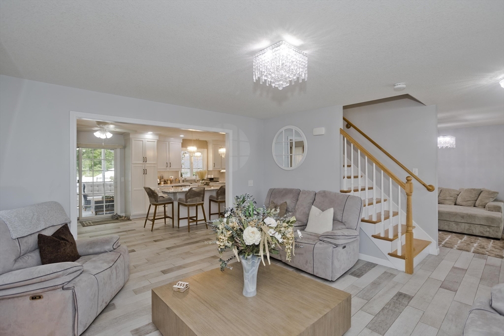 210 Naismith Street Springfield, MA 01104 - Photo 17 of 42 a living room with furniture and a chandelier