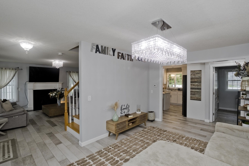 210 Naismith Street Springfield, MA 01104 - Photo 18 of 42 a bedroom with furniture and a chandelier