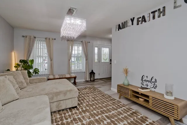a living room with furniture and a chandelier