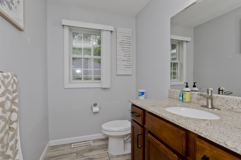 210 Naismith Street Springfield, MA 01104 - Photo 22 of 42 a bathroom with a granite countertop toilet sink and mirror