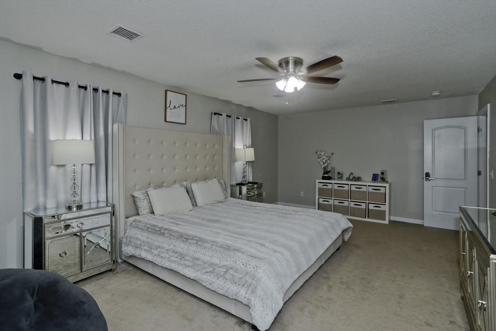 210 Naismith Street Springfield, MA 01104 - Photo 25 of 42 a bedroom with a bed and a chandelier