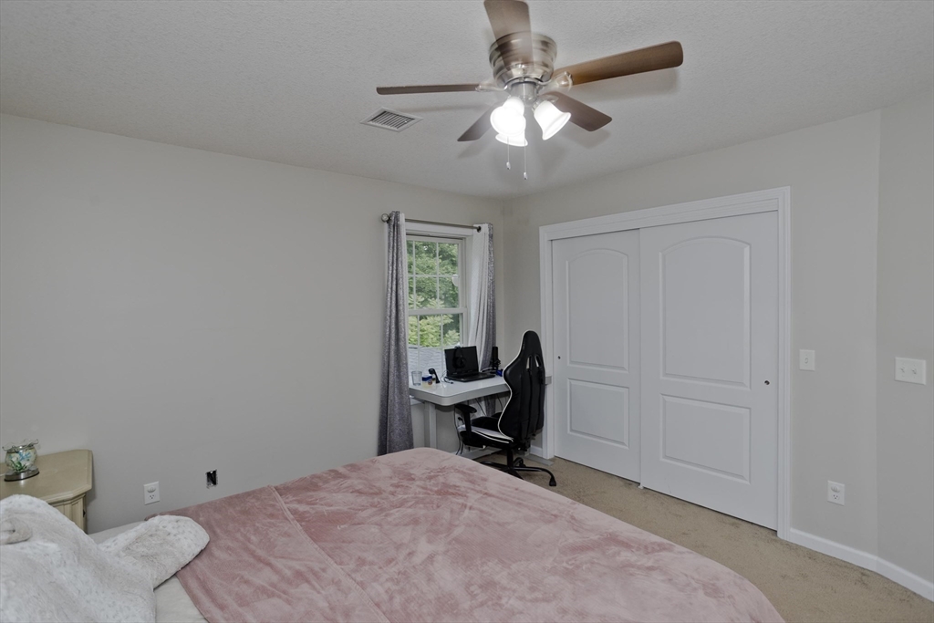210 Naismith Street Springfield, MA 01104 - Photo 30 of 42 a view of a workspace with furniture and a window