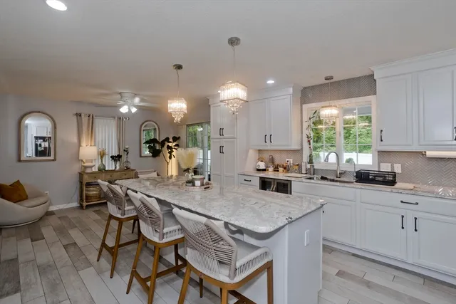 a kitchen with a table chairs stove and cabinets