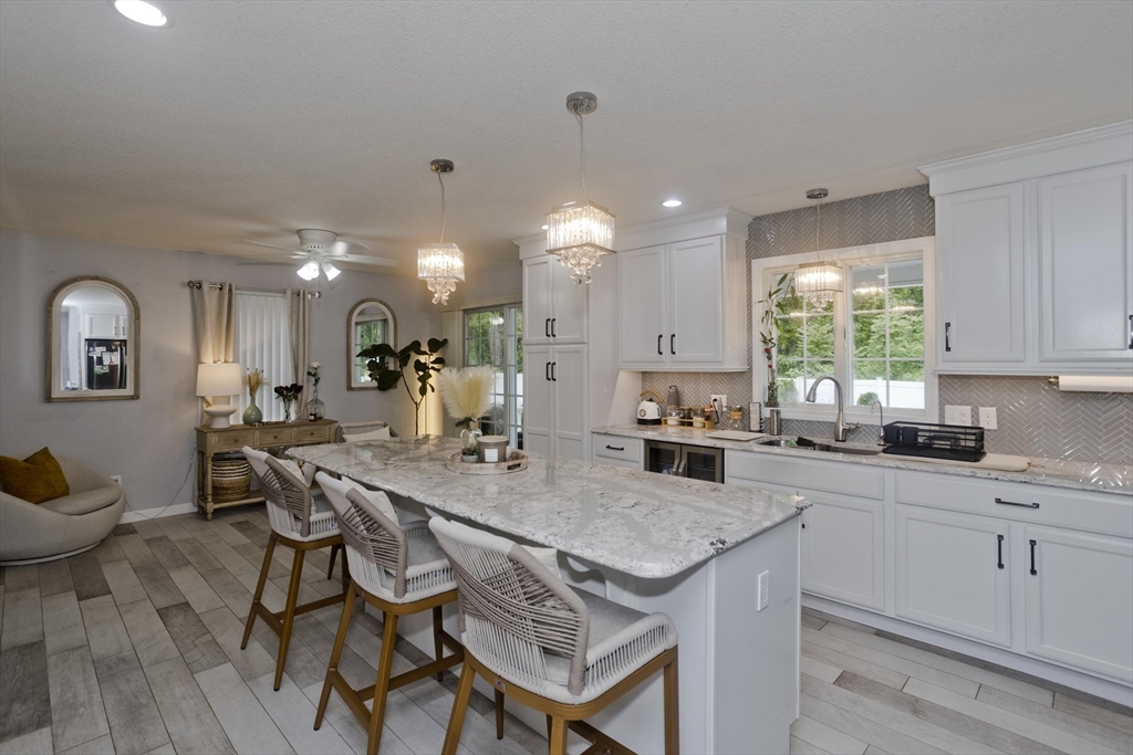 210 Naismith Street Springfield, MA 01104 - Photo 3 of 42 a kitchen with a table chairs stove and cabinets