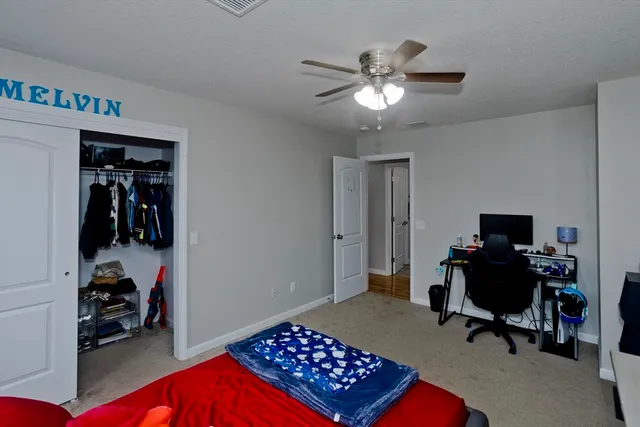 a bedroom with a workspace