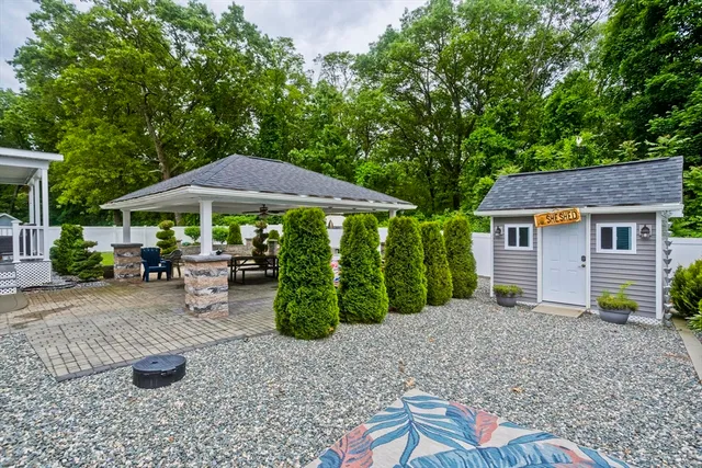 a view of a house with backyard and sitting area