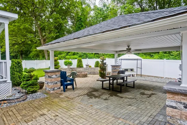 a view of a patio with table and chairs under an umbrella