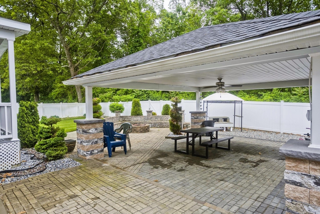 210 Naismith Street Springfield, MA 01104 - Photo 35 of 42 a view of a patio with table and chairs under an umbrella