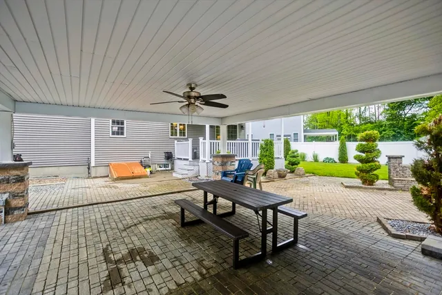 a living room with patio furniture and a large window