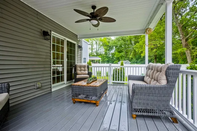 a balcony with wooden floor and outdoor seating
