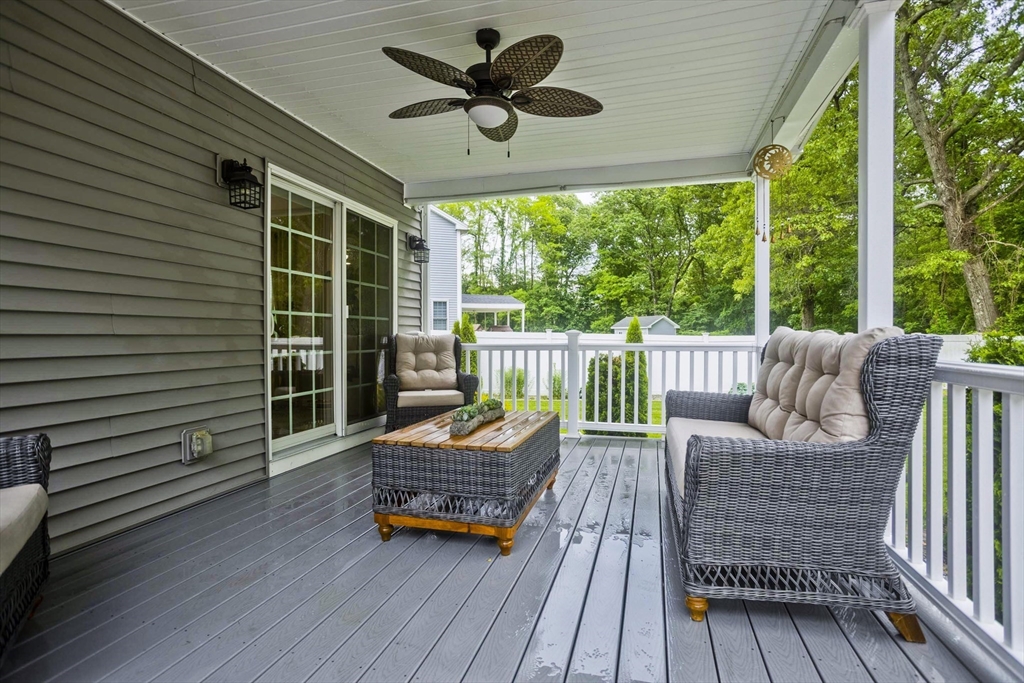 210 Naismith Street Springfield, MA 01104 - Photo 40 of 42 a balcony with wooden floor and outdoor seating