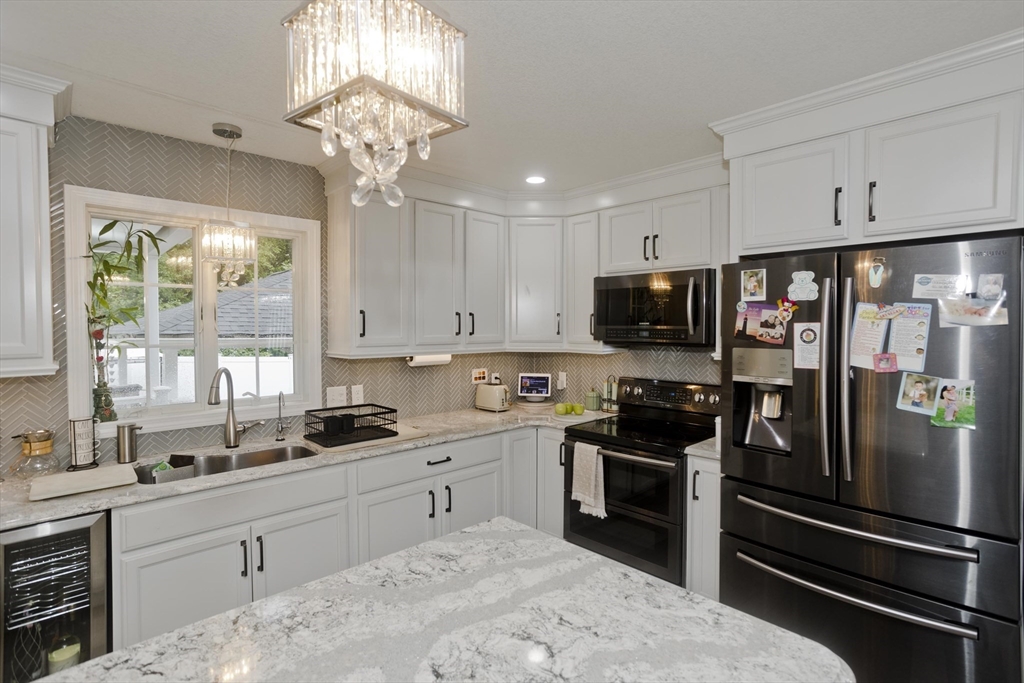 210 Naismith Street Springfield, MA 01104 - Photo 5 of 42 a kitchen with a sink stainless steel appliances and window