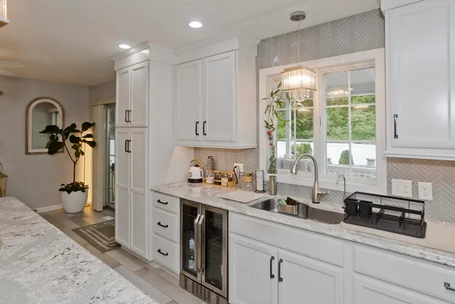a kitchen with stainless steel appliances granite countertop a sink a stove and a refrigerator