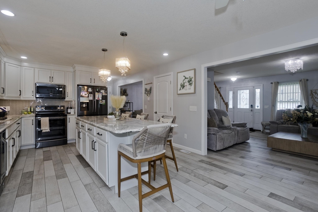 210 Naismith Street Springfield, MA 01104 - Photo 9 of 42 a kitchen with stainless steel appliances granite countertop lots of counter top space