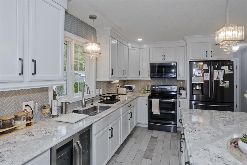 210 Naismith Street Springfield, MA 01104 - Photo 10 of 42 a kitchen with stainless steel appliances granite countertop a stove sink microwave and cabinets