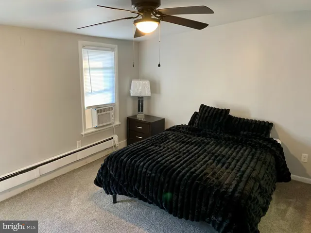 a view of room with window and a ceiling fan