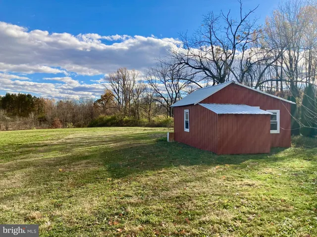 a backyard of a house with lots of green space and garden