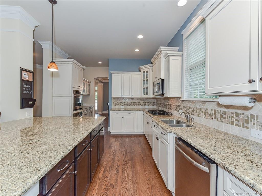 313 Olmstead Street Fort Mill, SC 29708 - Photo 11 of 48 a kitchen with a stove sink and cabinets
