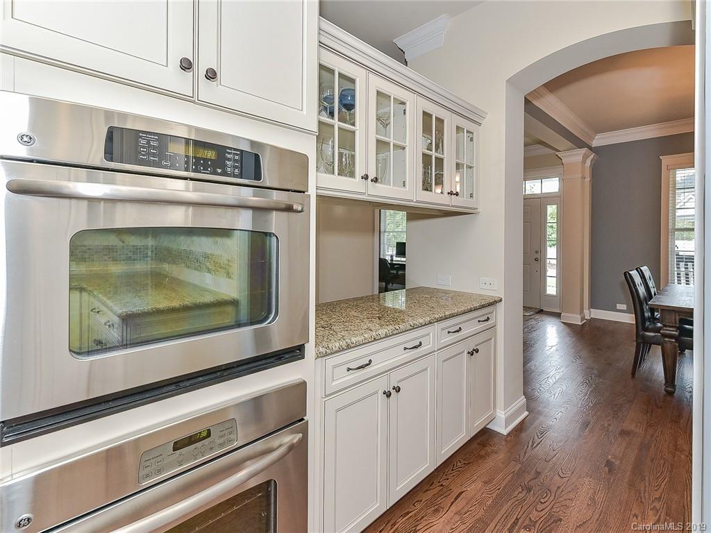 313 Olmstead Street Fort Mill, SC 29708 - Photo 14 of 48 a kitchen with stainless steel appliances granite countertop a stove and a wooden floors