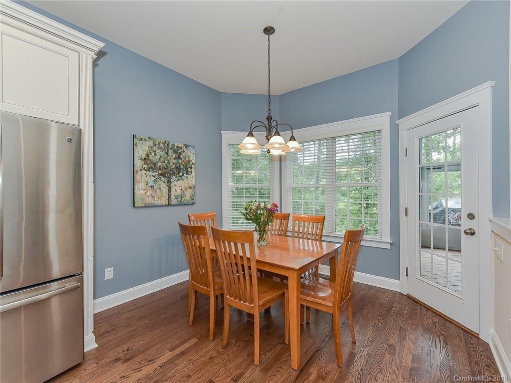 313 Olmstead Street Fort Mill, SC 29708 - Photo 16 of 48 a dining room with furniture a chandelier and wooden floor