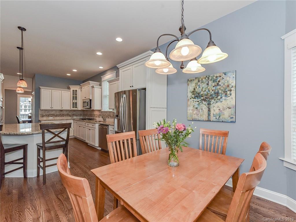 313 Olmstead Street Fort Mill, SC 29708 - Photo 17 of 48 a view of a dining room with furniture wooden floor and chandelier