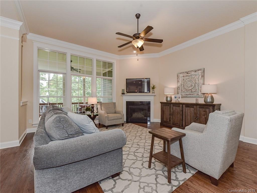 313 Olmstead Street Fort Mill, SC 29708 - Photo 18 of 48 a living room with furniture a fireplace and a flat screen tv