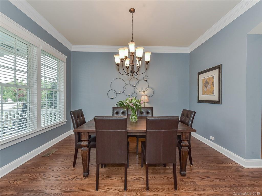 313 Olmstead Street Fort Mill, SC 29708 - Photo 8 of 48 a view of a dining room with furniture a chandelier and wooden floor