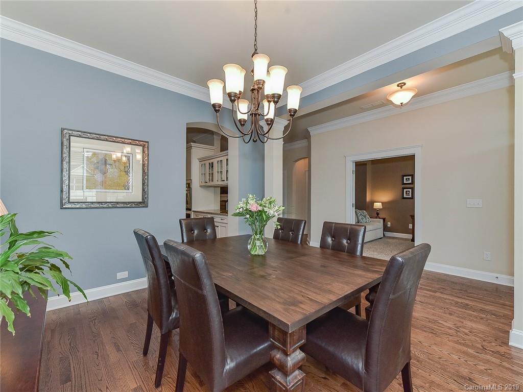 313 Olmstead Street Fort Mill, SC 29708 - Photo 9 of 48 a view of a dining room with furniture and wooden floor