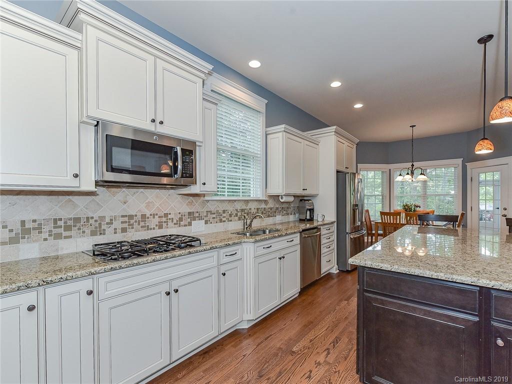 313 Olmstead Street Fort Mill, SC 29708 - Photo 10 of 48 a kitchen with stainless steel appliances granite countertop a sink stove and microwave
