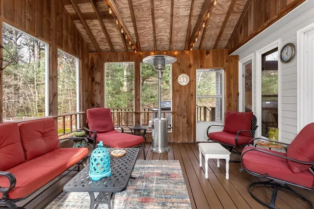 a living room with furniture a fireplace and large windows