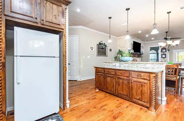 a view of a kitchen with a sink and a refrigerator