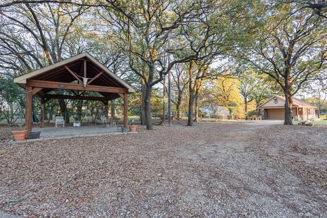 a view of a house with trees and backyard