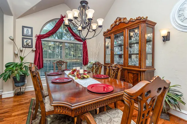 a view of a dining room with furniture wooden floor and chandelier