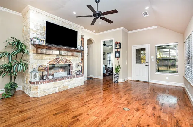 a view of a livingroom with a flat screen tv and a fireplace