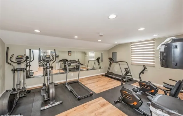 a room with gym equipment and windows