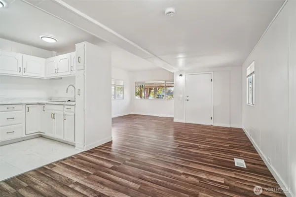 a view of a kitchen with wooden floor