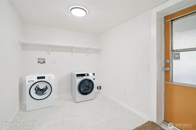 a view of storage and utility room with washer and dryer