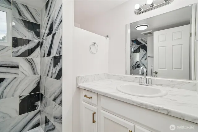 a bathroom with a sink and a mirror