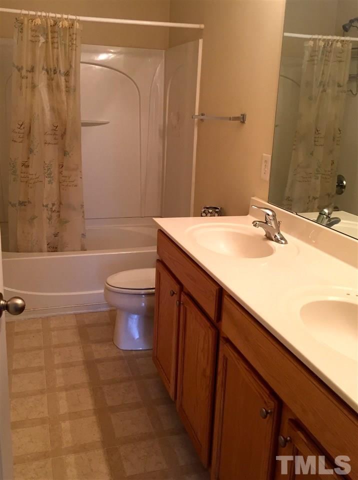 3720 Bison Hill Lane Raleigh, NC 27604 - Photo 4 of 9 a bathroom with a sink a toilet and shower