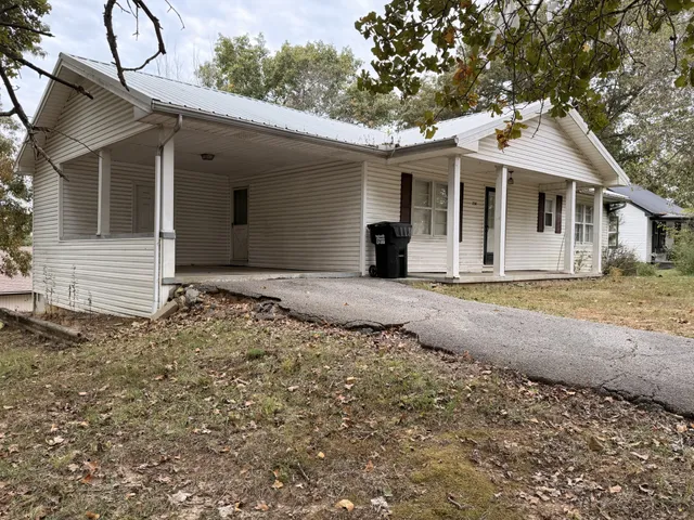 a front view of a house with a garden and yard