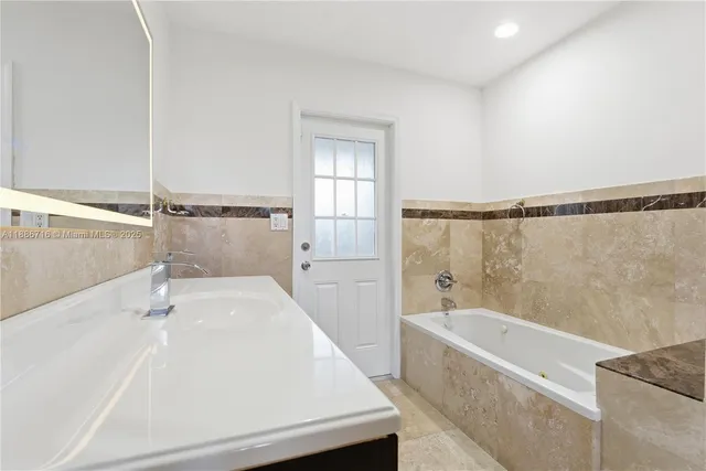 a bathroom with a bathtub and a shower