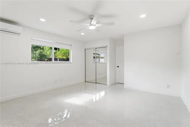 an empty room with windows and closet