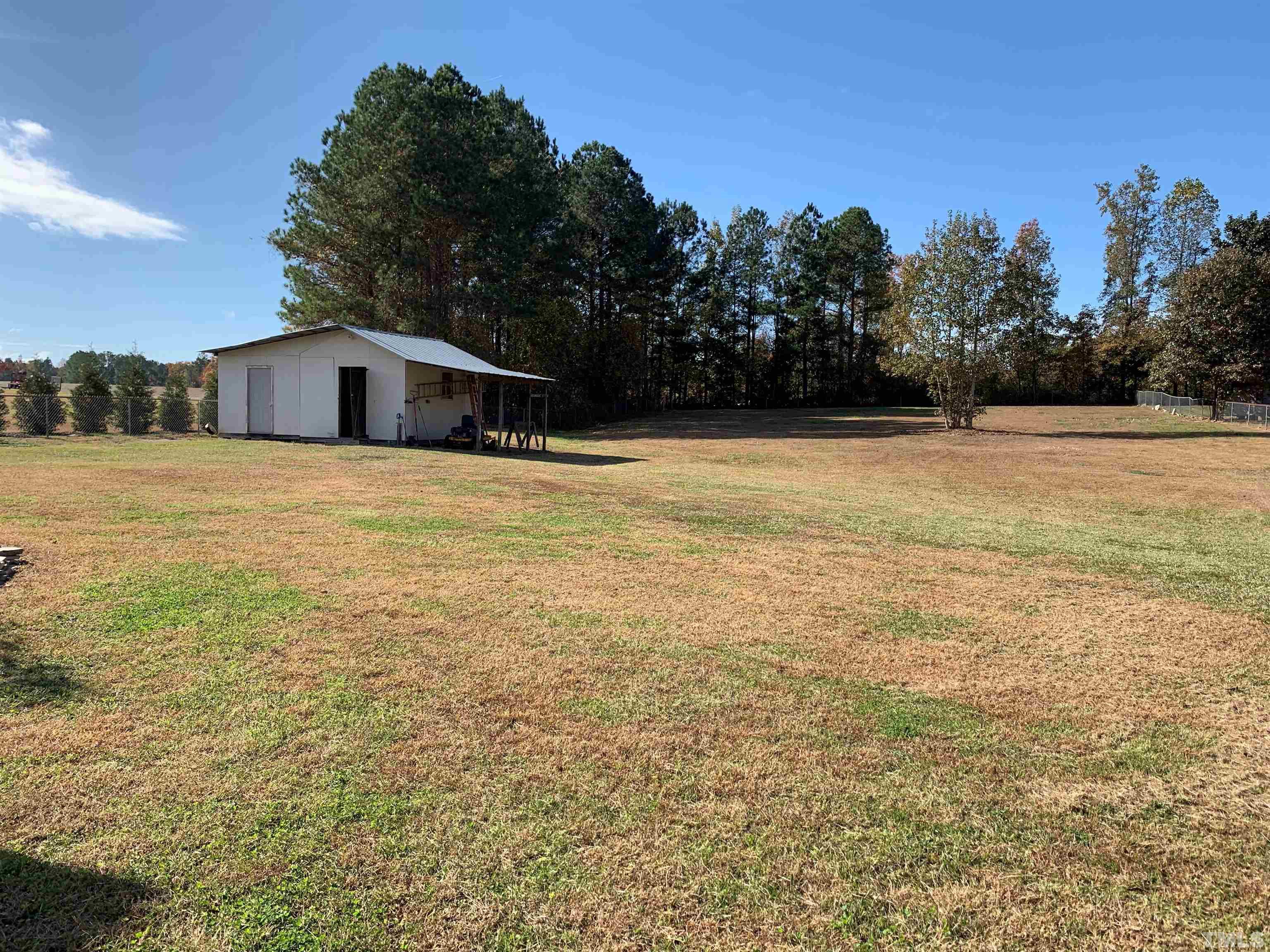 2316 Rolesville Road Wake Forest, NC 27587 - Photo 16 of 17 a house with yard and trees in the background