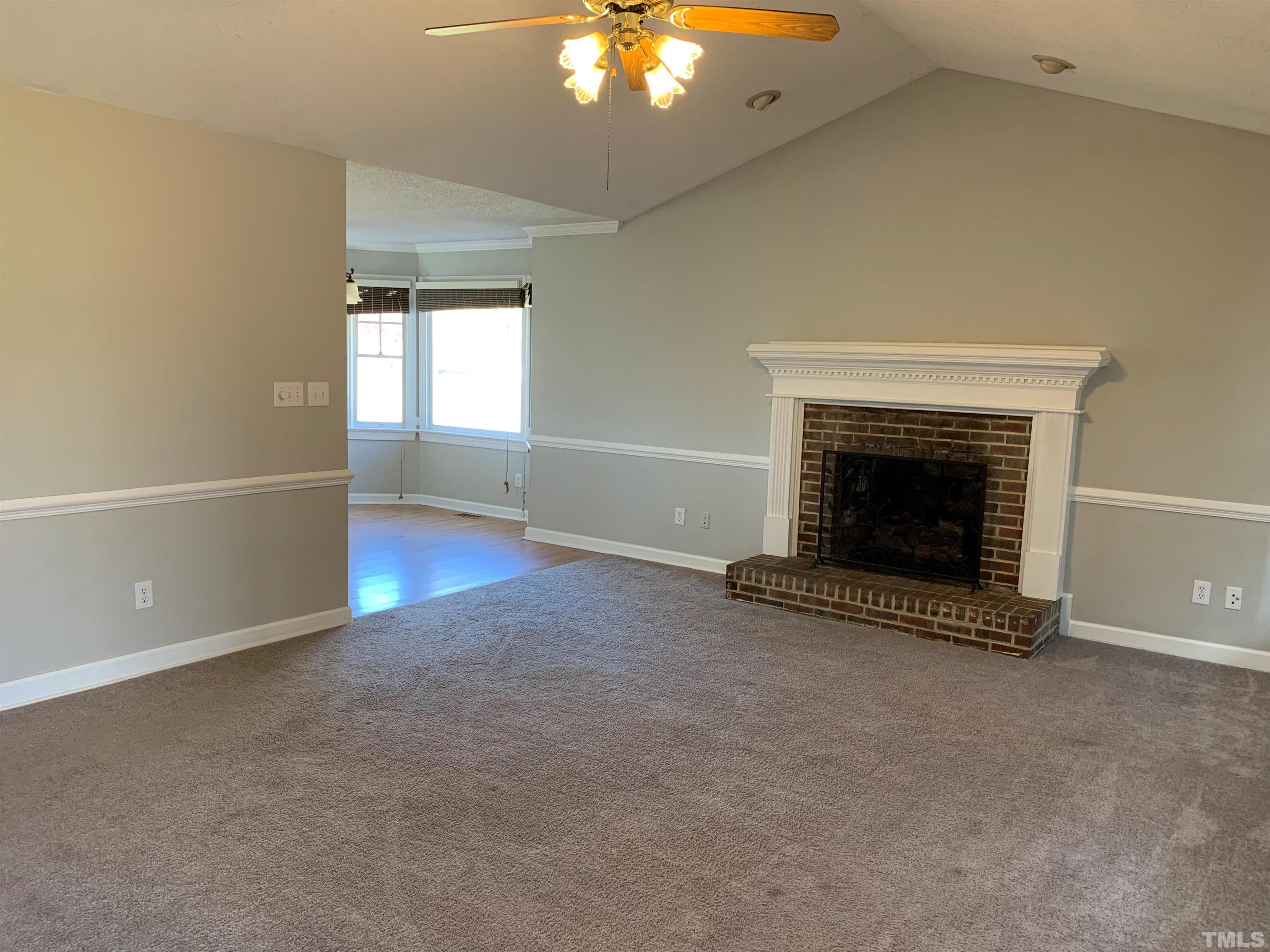 2316 Rolesville Road Wake Forest, NC 27587 - Photo 4 of 17 an empty room with windows and fireplace