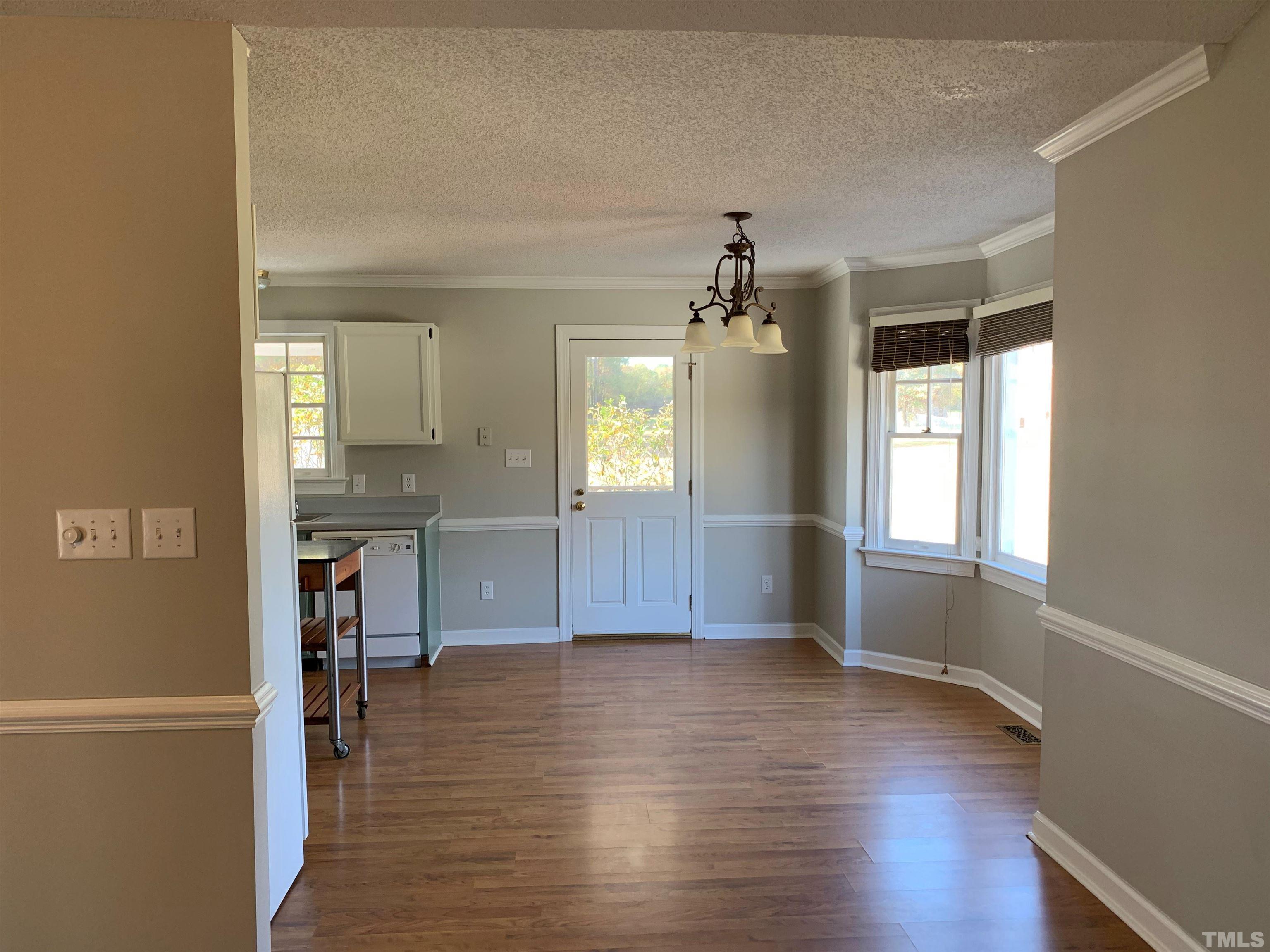2316 Rolesville Road Wake Forest, NC 27587 - Photo 6 of 17 an empty room with wooden floor and windows