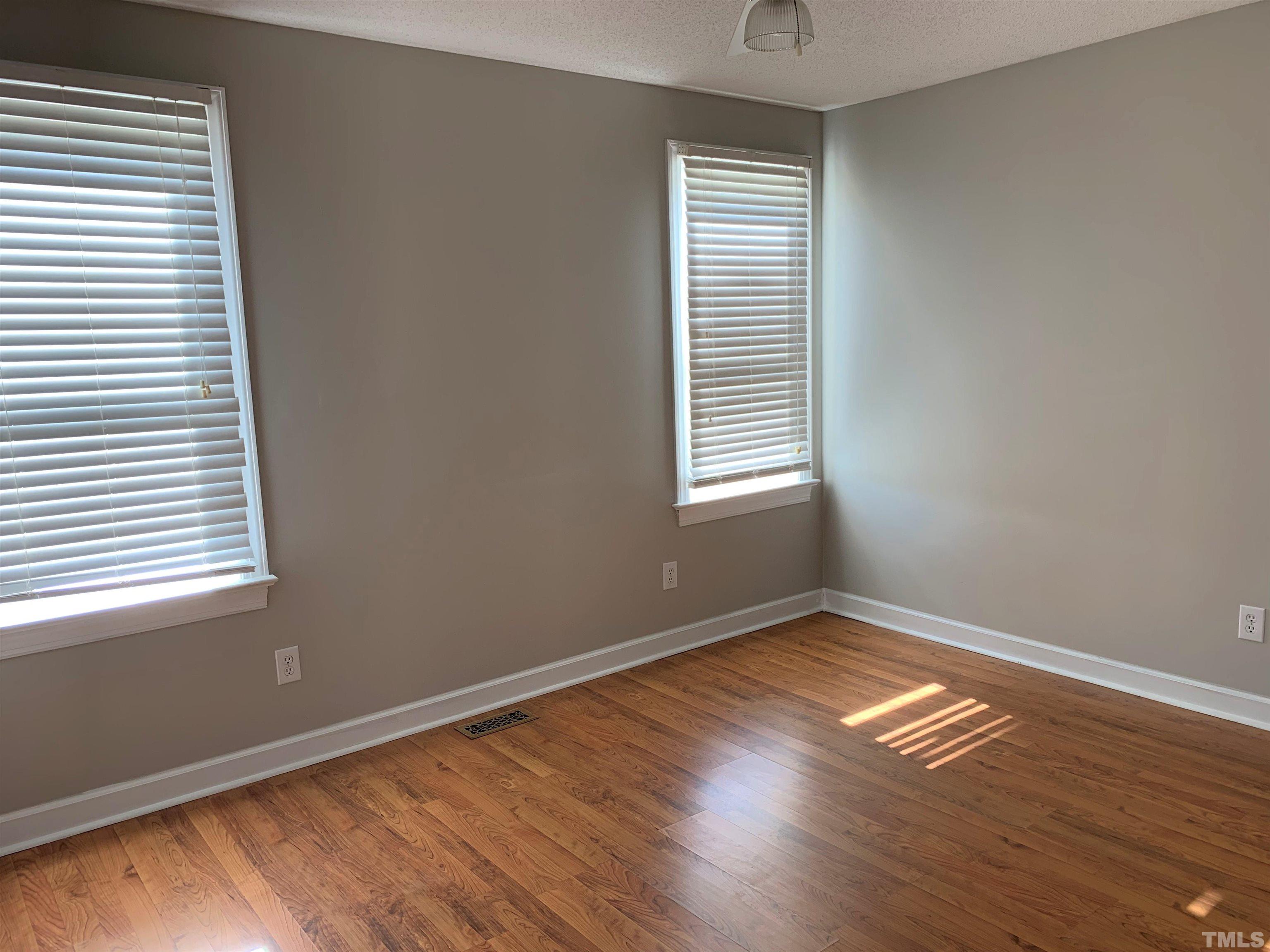 2316 Rolesville Road Wake Forest, NC 27587 - Photo 8 of 17 an empty room with wooden floor and windows