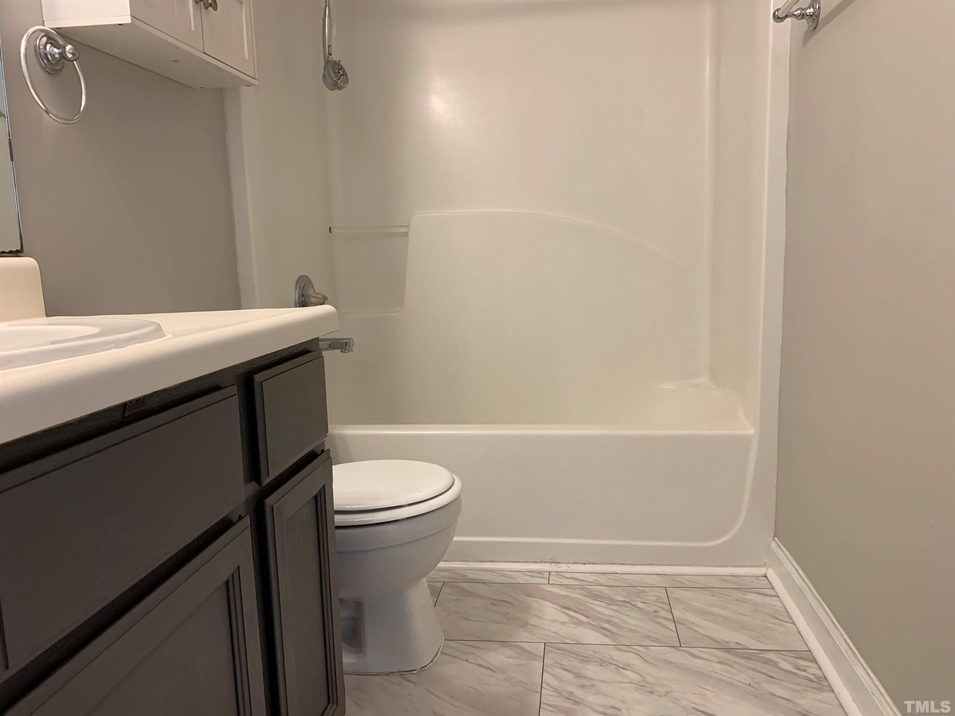 2316 Rolesville Road Wake Forest, NC 27587 - Photo 9 of 17 a bathroom with a sink a toilet and shower