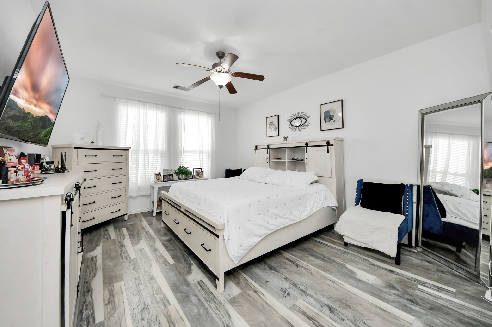 12119 Redbud Brook Trail Houston, TX 77089 - Photo 31 of 48 a bedroom with a bed and a flat tv screen on dresser