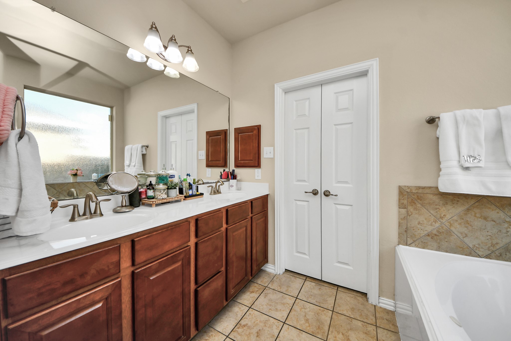 12119 Redbud Brook Trail Houston, TX 77089 - Photo 35 of 48 a spacious bathroom with a double vanity sink a mirror and a shower