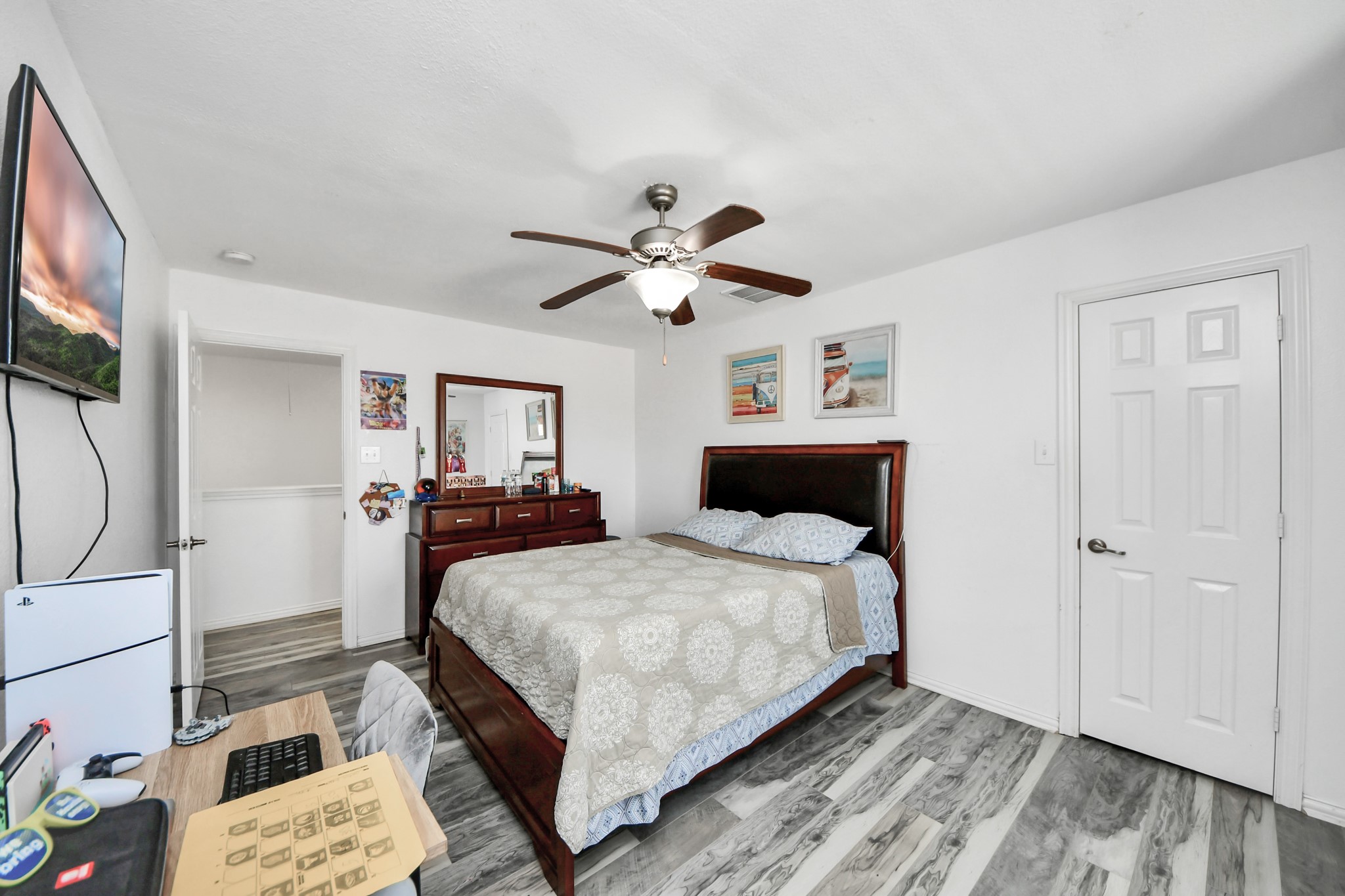 12119 Redbud Brook Trail Houston, TX 77089 - Photo 42 of 48 a bedroom with a bed and a chandelier